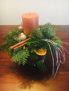 a candle and some branches on a table