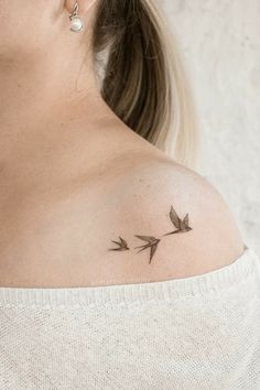 a woman with a small tattoo on her shoulder