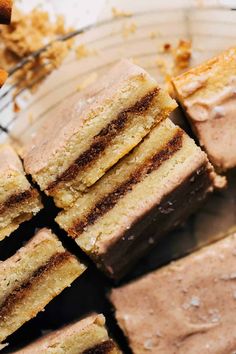 slices of cake sitting on top of a glass plate next to an orange slice and cinnamon stick