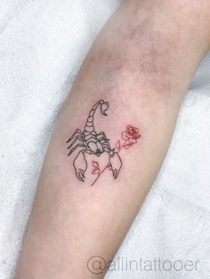 a small tattoo on the arm of a person with a rose in front of it