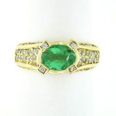 "This stunning ring was crafted from solid 18k yellow gold and features a gorgeous emerald solitaire with fine diamond accents throughout. The oval cut solitaire is prong set, displaying an amazing pure green color that gives this ring such a desirable look. The gallery and all sides of the shank are fully covered with round brilliant cut diamonds, creating a super bright and attractive look with nonstop sparkle. The top of the prong settings each feature a neatly set diamond as well for a beaut Brilliant Diamond, Sparkle Diamonds, Round Brilliant Cut Diamond, Cocktail Ring, Brilliant Cut Diamond, Oval Cut, Round Brilliant, Online Jewelry, Prong Setting