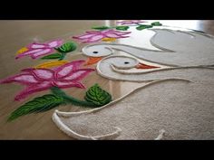 a close up of a rug with flowers on the floor and an elephant in the middle