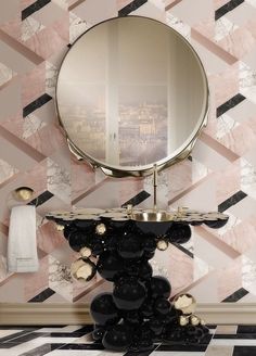 a bathroom with a mirror, sink and black and white tiles on the floor in front of it