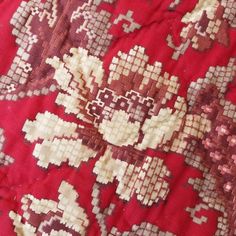 an old red and white flowered cloth with many small flowers on the bottom half