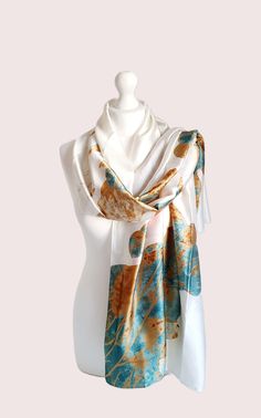 The Water Lily print Scarf is a luxurious and elegant accessory made from silk feeling premium polyester This beautiful scarf adds a touch of artistic flair to any outfit. Its soft and lightweight texture makes it perfect for draping around the shoulders or tying as a headscarf. This gift for her can be complemented with an optional gift box and card. Whether for a special occasion or everyday wear, this beautiful Scarf is a timeless and stylish addition to any woman's wardrobe. Perfect gift for her and your loved ones! Size: 90 x 180cm Transitional Style Perfect for all seasons Water Lily Design Art Print Scarf Luxury Scarf Care instructions : Cold wash only.  Do not bleach Do not tumble dry Iron in low temperature Elegant White Rectangular Scarves, Elegant Gold Rectangular Silk Scarf, Elegant Cream Silk Scarf As A Gift, Elegant Cream Silk Scarf For Gift, Elegant Cream Silk Scarf As Gift, Elegant Multicolor Rectangular Silk Scarf, Water Lily Design, Lily Design, Design Scarf