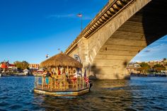 a boat is floating under a bridge on the water