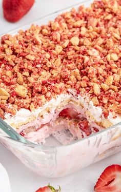 a dessert dish with strawberries and crumbled toppings on top, in a glass casserole dish