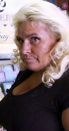 a woman with blonde hair is looking at the camera