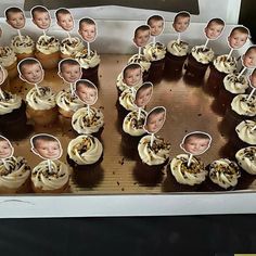 a bunch of cupcakes with pictures of babies in them on top of a table