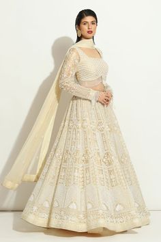 Ivory lehenga with all over pearl embroidered floral jaal and scallop patterns. Comes with padded pearl tasselled blouse and embroidered dupatta. Components: 3 Pattern: Embroidered Type Of Work: Pearl Neckline: Square Sleeve Type: Full Fabric: Organza  Color: Ivory Other Details:  Attached lining Lehenga length: 42 inches Weight: Approx 4-5 kgs Closure:  Lehenga: Side drawstring Blouse: Back hook Occasion: Wedding,Bride,Destination Wedding - Aza Fashions Ivory Lehenga, Indian Bridesmaid Dresses, Lehenga Pattern, Anushree Reddy, Full Sleeve Blouse, Organza Lehenga, Lehenga Designs Simple, Bridal Elegance, Bridal Lehengas