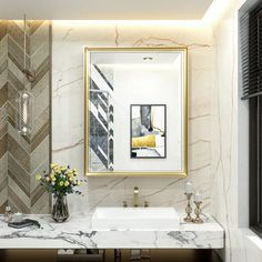 a bathroom with marble counter top and gold framed mirror above the sink, along with two vases filled with flowers