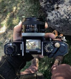 a person holding up a camera in their hand