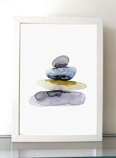 a watercolor painting of rocks stacked on top of each other in a white frame