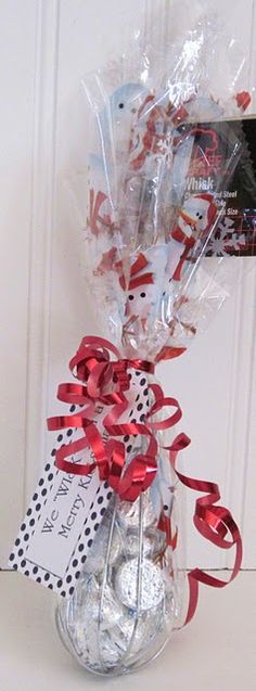 a bunch of candy wrapped in cellophane and tied to a door with red ribbon