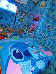 a bed room with a neatly made bed and lots of stuffed animals on the wall