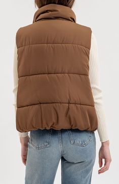 Whether you're deep in the backcountry or just your own backyard, you'll appreciate the cozy core warmth of this vest filled with polyester insulation. 24" length Front zip closure Stand collar Front welt pockets Lined, with 100% polyester fill 100% polyester Machine wash, line dry Made in China Brown Northface Vest, Brown Puffer Vest Women, Puffy Vest Brown, Brown Puffer Gilet, Cozy Core, Womens Tailored Suit, Quilted Puffer Vest, Flannel Tops, Graphic Tops