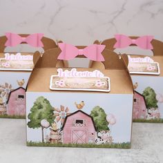 three boxes with pink bows and farm animals on the front, one has a bow tie