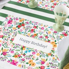 a birthday card on a table with flowers