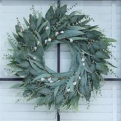 a wreath is hanging on the front door