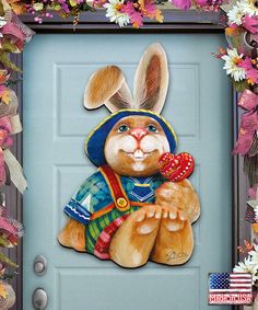 a painting of a rabbit with a hat and scarf on it's head, sitting in front of a blue door