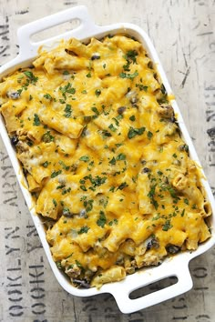 a casserole dish with cheese and mushrooms in it