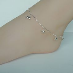 Sterling silver speciality chain anklet. Comes with tiny puffed heart charms. Also ends with a tiny bell. Length: 10 inches. Hearts : 5 x 6 mm Bell: 7mm Price listed is for ONE piece. These anklets are made of 925 hypoallergenic sterling silver. All my pieces are sent in a gift box. I can include a personal message from you if needed. You are welcome to contact me at... bhavnakwintra1956@gmail.com For more beautiful pieces from my shop, please browse 👇 TOE RINGS: https://www.etsy.com/your/shops Silver Dangle Metal Anklets, Silver Dangle Anklets, Dainty Sterling Silver Anklets, Silver Minimalist Metal Anklets, Minimalist Silver Metal Anklets, Adjustable Silver Heart Anklets, Silver Adjustable Heart-shaped Anklets, Silver Heart-shaped Anklets As Gift, Dainty Silver Heart Anklets