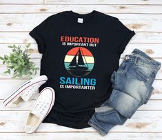 "* All shirts are unisex. * Product measurements may vary by up to 2 inches. * All Designs are originally made by myself or my team.  Sailing shirt with the quote \"Education Is Important But Sailing Is Importanter\" is a fun gift for men and women!  To see more designs of your topic Sailing you can search & find them in the store:   https://www.etsy.com/shop/Retailorie  You find there also an announcement if the shipping & production times change :) funny boating shirts,sailing shirt,sailboat shirt,sail boat shirt,sail shirt,sailing t shirt,sailing tshirt,sailing boat,cruise shirts,sailing gift,sailing t-shirt," Graphic Print Cotton T-shirt For Sailing, Boating Shirts, Quote Education, Boat Humor, Boat Shirts, Cruise Shirt, Best Gifts For Men, My Team, By Myself