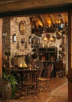 an old fashioned kitchen and dining room with brick walls