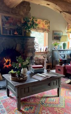 a living room filled with furniture and a fire place in the middle of a room