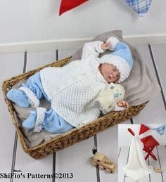 a baby doll is laying in a basket