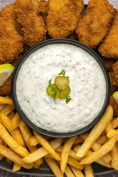 a plate filled with fries and dipping sauce