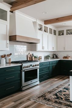 a kitchen with green cabinets and white walls