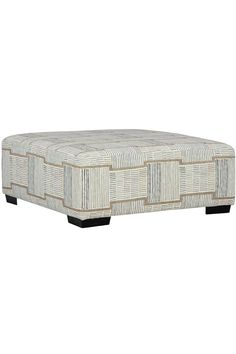 the footstool is made out of woven material and has black legs, with an intricate