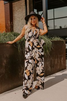 - Kick back and enjoy some vacay vibes in this stylish jumpsuit! - Unlined material with an abstract floral print - A v-cut neckline with a twist detail - Adjustable spaghetti straps - A smocked upper back with a tie detail - A wide legged jumpsuit with floor length hemlines Chic Floral Print Jumpsuits And Rompers For Beach, Black Printed Jumpsuits And Rompers For Beach, Chic Floral Print Beach Jumpsuit, Chic Beach Jumpsuit With Floral Print, Chic Black Printed Jumpsuits And Rompers, Black Printed Jumpsuit For Beach, Black Floral Print Jumpsuits And Rompers For Vacation, Black Floral Print Jumpsuit For Vacation, Chic Printed Jumpsuits And Rompers For Vacation