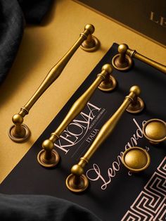 an assortment of handles and knobs in gold on a black card with a golden background