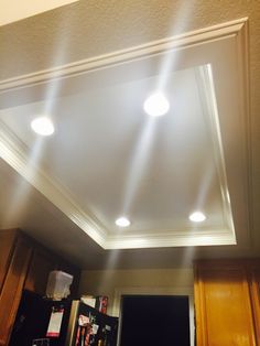 the lights are shining down on the kitchen ceiling