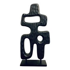 a black sculpture on a white background