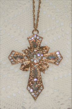 This goldtone necklace features a striking very large, heavy point armed pectoral cross pendant with tons of sparkle and shine!  It has a raised openwork center with a keyhole in the middle surrounded by pave-set white/clear crystal glass rhinestones that capture the light beautifully!  The body has a leafy starburst aura with faceted aurora borealis acrylic oval insets.  It is a gorgeous piece that's hard to capture fully in a picture.  The reverse has a shiny finish and the chain is 24 inches Symbol Jewelry, Pectoral Cross, Dope Jewelry Accessories, Mexican Jewelry, Jewelry Accessories Ideas, Dope Jewelry, Key To My Heart, Jewelry Fashion Trends, Expensive Jewelry