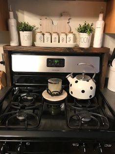 a stove top oven sitting next to a counter with pots and pans on it