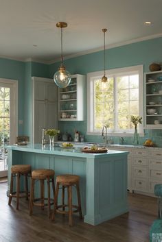 a kitchen with blue walls and wooden floors, two bar stools at the island