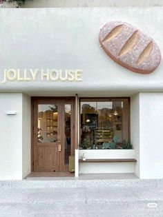 a store front with the name jolly house written on it's door and window sill