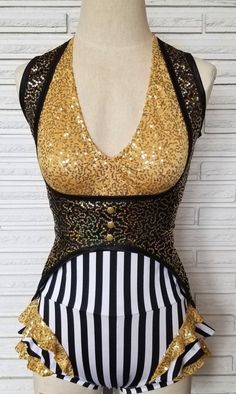 a mannequin with gold sequins and black and white stripes on it