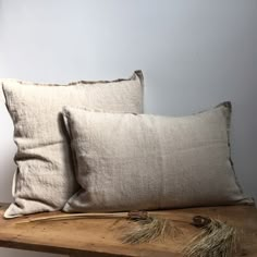 two pillows sitting on top of a wooden table