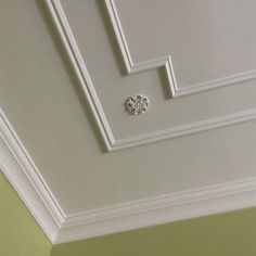 the ceiling is painted white and has a small diamond on it's center piece