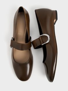 The Gabine returns in one of the must-have styles of the season -- the Mary Janes. These leather shoes are truly deserving of a spot in your capsule wardrobe. Crafted with genuine box leather, they are made to last. In deep espresso-brown, this pair exudes a preppy charm that will add a youthful element to all your looks. It also features thick straps across the vamps, along with silver-tone Gabine accents for a distinctive touch. Brown Mary Jane Flats, Womens Work Shoes, Capsule Wardrobe Shoes, Brown Flat Shoes, Brown Mary Janes, Timeless Shoes, Clear Shoes, Work Shoes Women, Embellished Flats