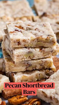 several pieces of pecan bar stacked on top of each other with nuts around them