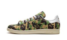 The BAPE x adidas Stan Smith "ABC Camo" is a collaboration by the legendary Japanese streetwear on the equally iconic tennis shoe that features BAPE’s signature camo print.  The adidas Samba “ABC Camo” by BAPE features the streetwear brand’s “ABC Camo” in an all-over-style pattern, giving the shoe a bold look.  Perforated Three Stripes branding appears on the sides, while gold foil “Stan Smith” detailing is seen on the lateral side of the shoe.  The tongue of the left shoe has a classic Stan Smi Sporty Camouflage Sneakers For Sports, Adidas Casual Custom Sneakers For Streetwear, Camouflage Round Toe Sneakers For Streetwear, Camouflage Sneakers With Round Toe For Sports, Camouflage Round Toe Sneakers For Sports, Adidas Custom Sneakers For Streetwear With Round Toe, Adidas Custom Sneakers With Vulcanized Sole For Streetwear, Adidas Custom Sneakers With Round Toe For Streetwear, Camouflage Lace-up Sneakers For Streetwear