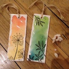 two tags with dandelions and leaves on them