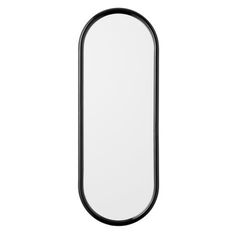 an oval mirror on a white wall with black trimmings and a black frame