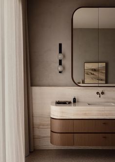 a bathroom with a sink, mirror and shower curtain in the corner next to it